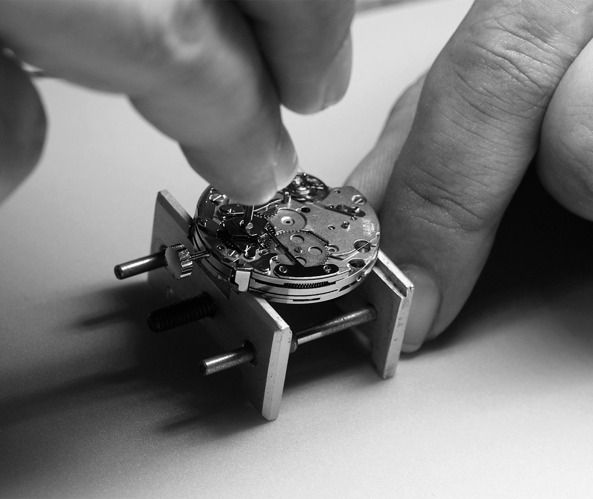 A watchmaker assembling a movement